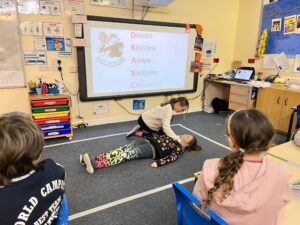 image of children doing the recovery position in the Falkland Islands